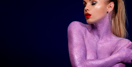 Woman with bodypaints isolated on black background. Portrait of sexy TDJ at the night club party. Mixtape or book cover design - download high resolution picture for your song cover. Horisontal bannerの写真素材