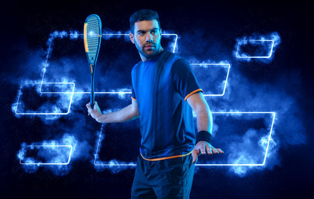 Squash player on a squash court with racket. Man athlete with racket on court with neon colors. Sport concept. Download a high quality photo for the design of a sports app or betting site.の写真素材