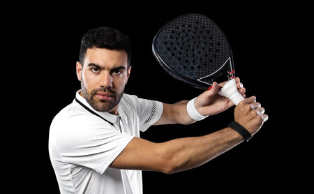 paddle tennis player. Man athlete with paddle tennis racket on black background. Sport concept. Download a high quality photo for sports website.の写真素材