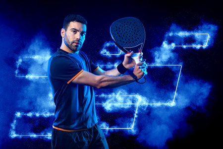 paddle tennis player with racket. Man athlete with paddle racket on court with neon colors. Sport concept. Download a high quality photo for the design of a sports app or betting site.の写真素材