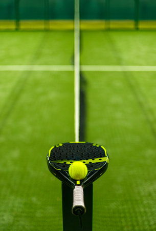 Padel tennis racket. Sport court and ball. Download a high quality photo with paddle for the design of a sports app or soical media advertisementの写真素材