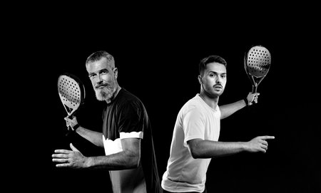 Padel open tour. Padel tennis players doubles. Two men athletes with paddle racket on court. Sport concept. Download a high quality photo for the design of a sports app or soical media advertisementの写真素材