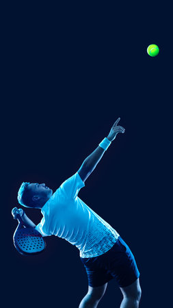 Padel tennis player. Padel open tour. Man athlete with paddle tenis racket and ball on blue background. Sport concept. Download a high quality photo for sports ads at social media stories or shorts.の写真素材