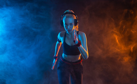 Runner running. Athlete sprinter run. Fit woman Influencer in neon colors. Download photo for advertising a fitness club in social networks. Cover for sport motivation music or video.の写真素材