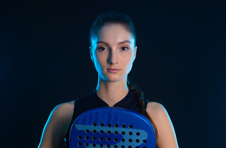 Close up portrait of padel tennis player with racket on tournament. Girl athlete with paddle racket on court. Sport concept. Download a high quality photo for design of a sports app or tour events.の写真素材