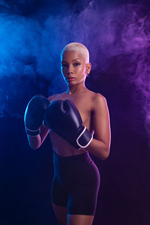 The Boxing. Brazilian woman boxer. Sportsman muay thai boxer fighting in gloves. Isolated on black background. Copy Space.の写真素材