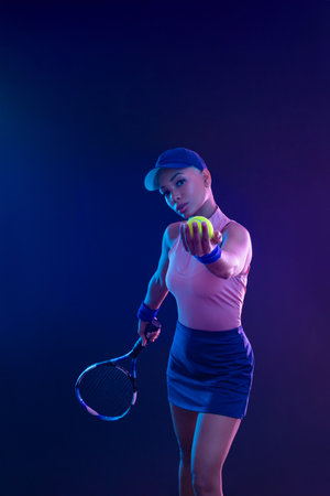Tennis player woman with racket on tournament. Girl athlete with tenis racket on court with neon colors. Sport concept. Download a high quality photo for design of a sports app or tour events.の写真素材