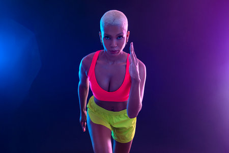 Runner banner with neon lights. Running template for ads design with copy space.の写真素材