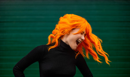 Happy smiling girl dancing. Girl dancer with creative colored hair and hairstyle. Lifestyle photo....