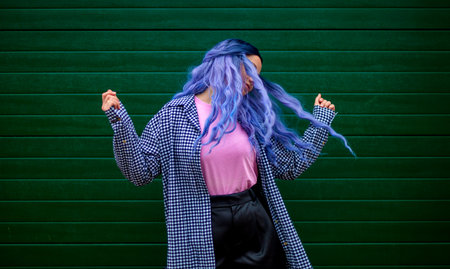 Happy woman dancing. Girl dancer with creative colored hair and hairstyle. Lifestyle photo. Cosplay...