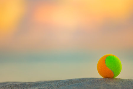 Beach tennis ball. Background with copy space. Sport court at the beach and ball.の写真素材