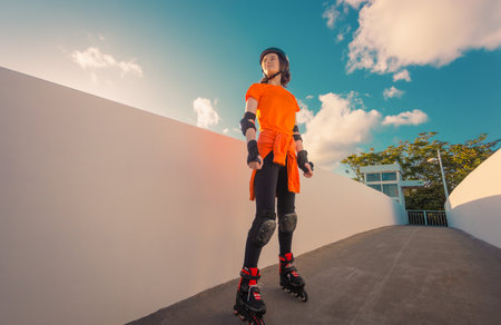 Roller skating teen in outdoors rollerblading on inline skates. Young girl in outdoor activities. Social media template.の写真素材