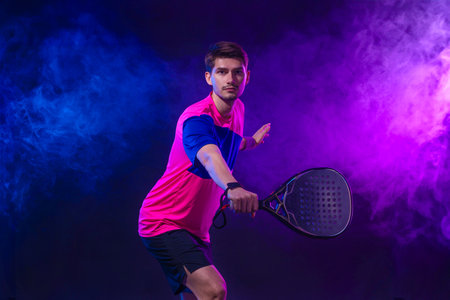 Padel Tennis Player with Racket in Hand. Paddle tenis, on a blue background. Download in high...