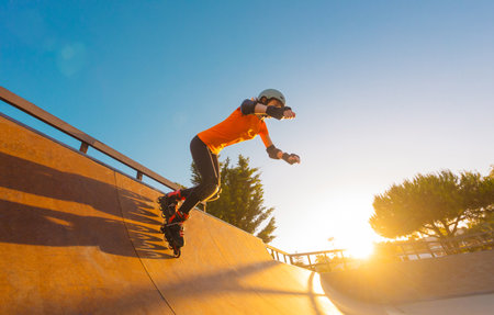 Roller skating teen in outdoors rollerblading on inline skates. Young girl in outdoor activities. Social media template.の写真素材