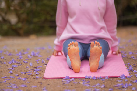 A woman practice outdoor yoga at the park. Calmness and relax. Photo in high resolution with yoga trainer.の写真素材