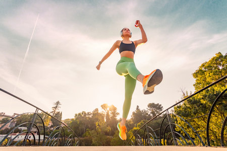 Runner outdoor. Strong athletic woman running in the park at summer. Fitness and sport motivation....
