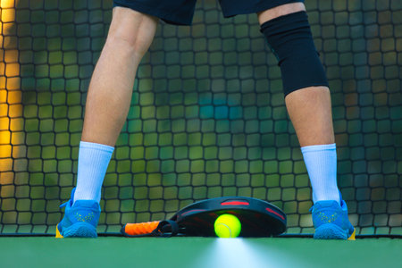 Padel tennis racket. Background with copy space. Sport court and balls.