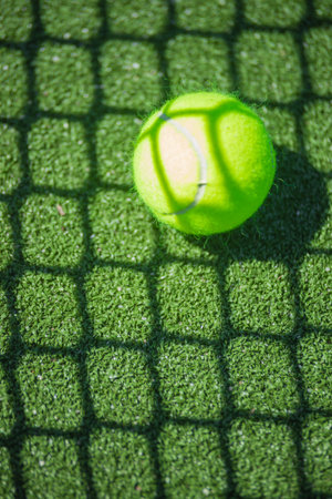 Padel or tennis ball. Background with copy space. Sport court and ball. Social media template. Promotion for padel and tennis events.の写真素材