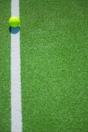 Sporty scene with padel ball on outdoor green court, stock photo for athletic branding, leisure concepts and padel club advertisingの写真素材