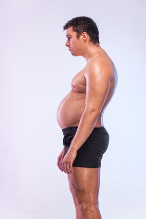 Man want to lose weight and become a slim athlete. Fitness concept.の写真素材