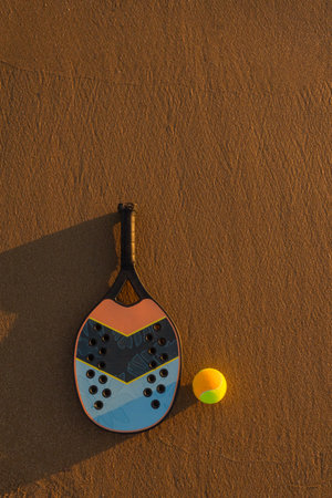 Scenic coastal evening with beach tennis gear illuminated by warm sunlight. Great inspiration for nature sport and summer holidays.の写真素材