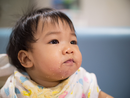 Soft focus asian girl with dirty mouthの写真素材