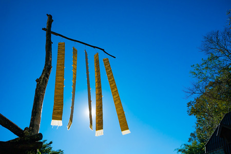 thai lanna flag hanging on pillar wood