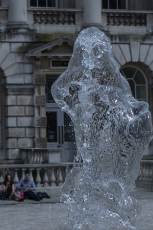 Two people viewing a an interesting water statueの写真素材