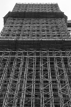 Large mult-story building enclosed by a scaffolding structureの写真素材