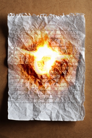 burning note paper on warm backgroundの写真素材