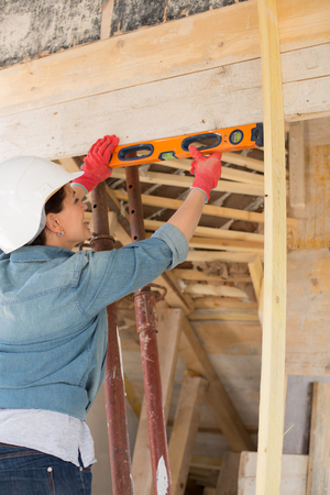 Attractive woman works on a construction site of a house
