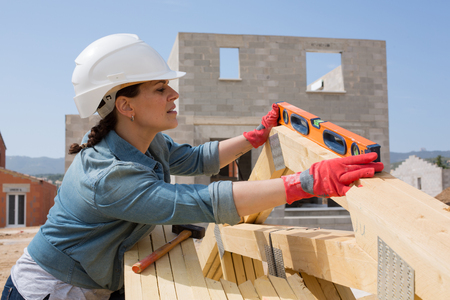 Attractive woman works on a construction site of a houseの写真素材
