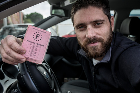 Man show his license driver with smileの写真素材