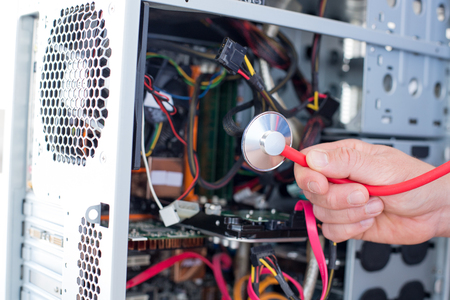 Man repairs computer / Doctor computerの写真素材