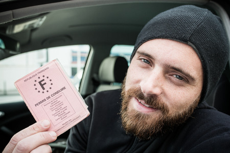 Man show his license driver with smileの写真素材