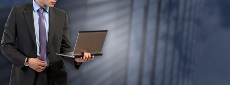 businessman with laptop isolated modern backgroundの写真素材