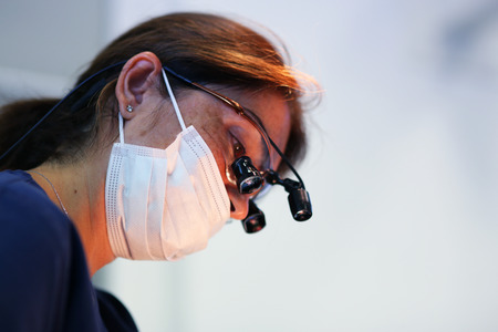 Dental surgery a female doctor working on a patientの写真素材