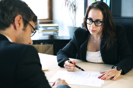 Job interview. Business woman interrogates a candidateの写真素材
