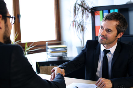 Job interview. Businessman interrogates a candidateの写真素材