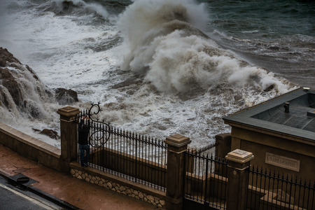 Stormy background with Big Waves Splash Against Cityのeditorial素材