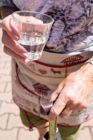 Elderly woman with glass of water in handの写真素材