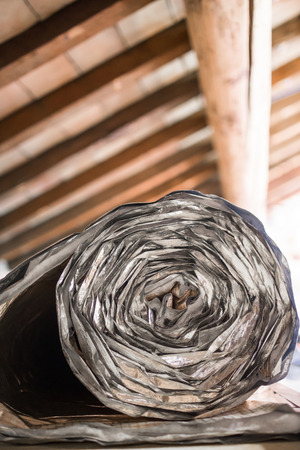 Roll of insulating on an attic floorの写真素材