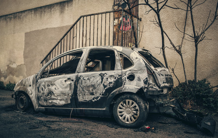 Burnt car wreck in small street of Marseille City. Criminal arsonの写真素材