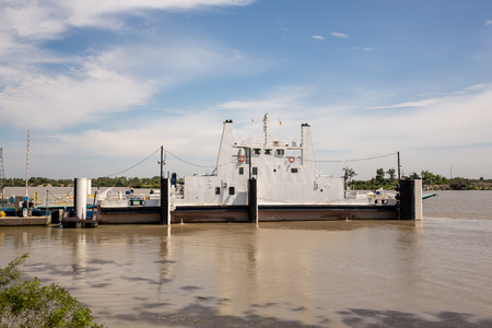 Ferry Boat carrying vehicles and tourists crosses the Rhone in France, French Camargueの写真素材