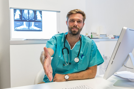 Young surgeon doctor reaches out to usの写真素材