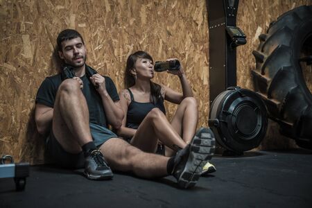 Attractive young people after workout exercises, fitness and healthy concept
