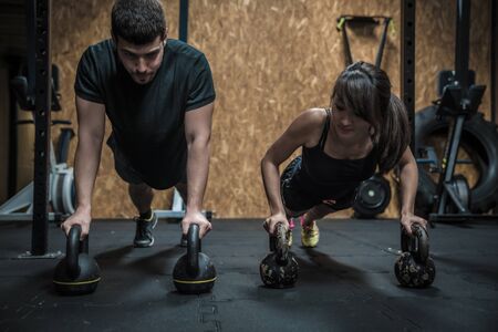 Fitness trainer with asian woman on trainingの写真素材
