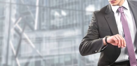 businessman seated watchs his watchの写真素材