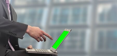 Businessman sitting in office with green screenの写真素材