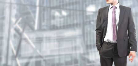 Businessman follows and tie standing relaxedの写真素材